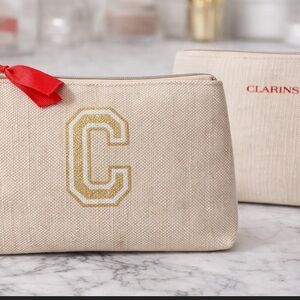Clarins Cream Cosmetic Bag with Gold and Red Details